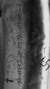 B&W photo, Conn bass saxophone with graffiti on the bell